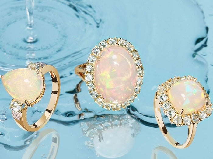 Three opal engagement rings with diamond halos, showcasing different opal shapes and settings in shimmering gold