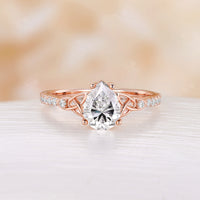 Celtic Inspired Pear Cut Moissanite Engagement Ring Rose Gold Pave Band